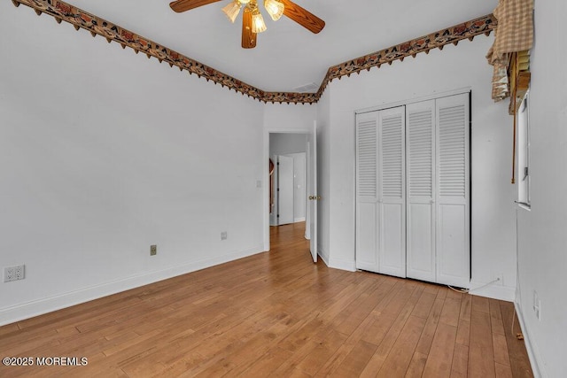 unfurnished bedroom with light wood finished floors, a closet, and baseboards