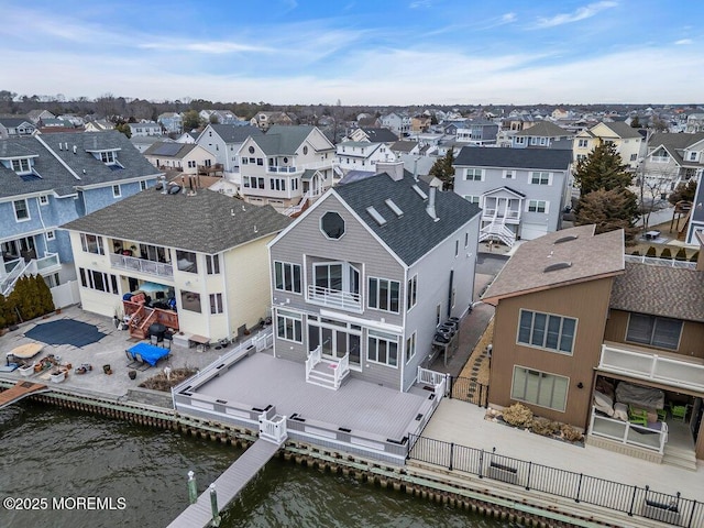 birds eye view of property featuring a water view and a residential view