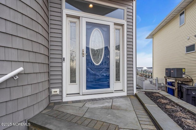 property entrance with fence and central AC unit