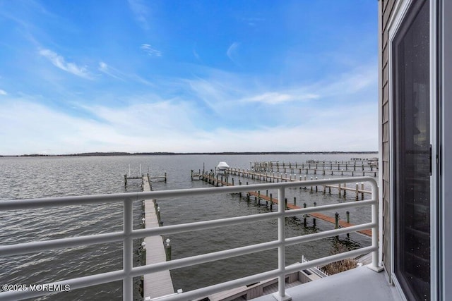 balcony featuring a dock and a water view