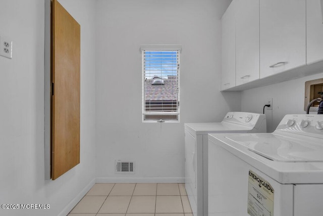 laundry area featuring cabinet space, visible vents, baseboards, washing machine and clothes dryer, and light tile patterned flooring