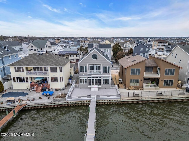 drone / aerial view with a water view and a residential view