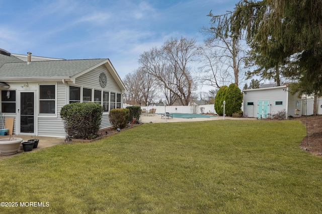 view of yard featuring a fenced in pool, a sunroom, a patio, and fence