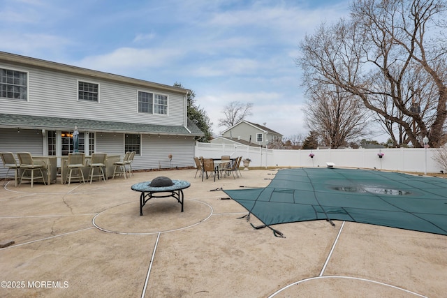 view of swimming pool with a fenced in pool, a patio, outdoor dining space, an outdoor fire pit, and fence