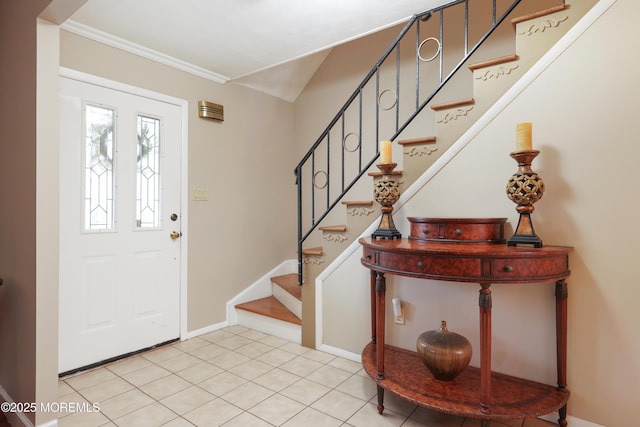 foyer entrance featuring ornamental molding, stairway, baseboards, and light tile patterned floors