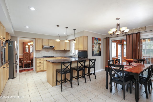 kitchen featuring an inviting chandelier, appliances with stainless steel finishes, a sink, and light brown cabinetry