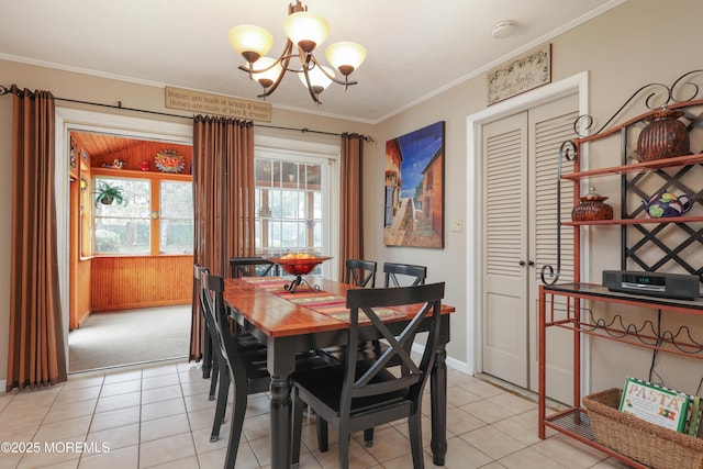 dining space featuring baseboards, a chandelier, crown molding, and light tile patterned flooring