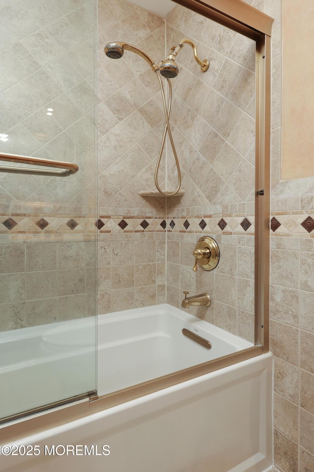 bathroom featuring shower / bath combination with glass door