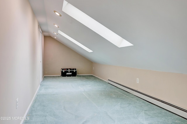 bonus room with vaulted ceiling with skylight, carpet, baseboards, and baseboard heating