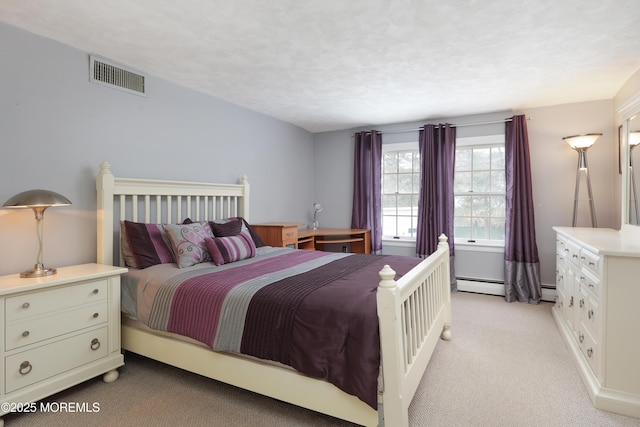 bedroom featuring light carpet, a baseboard heating unit, visible vents, and a textured ceiling