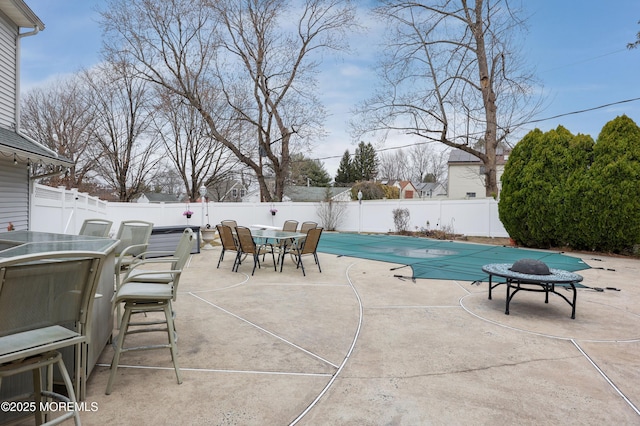 view of swimming pool featuring a fenced backyard, a patio, a fenced in pool, and outdoor dining space