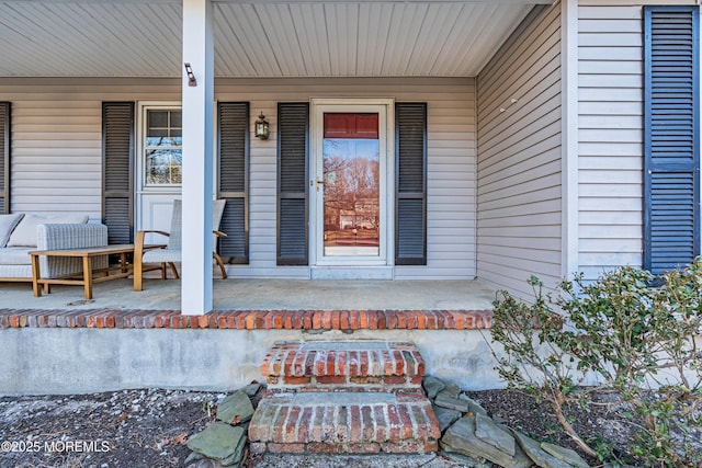 view of exterior entry with covered porch