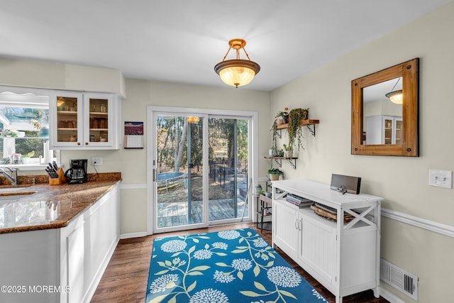 interior space featuring wood finished floors, visible vents, and baseboards