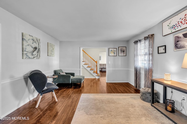 living area featuring stairs, wood finished floors, and baseboards