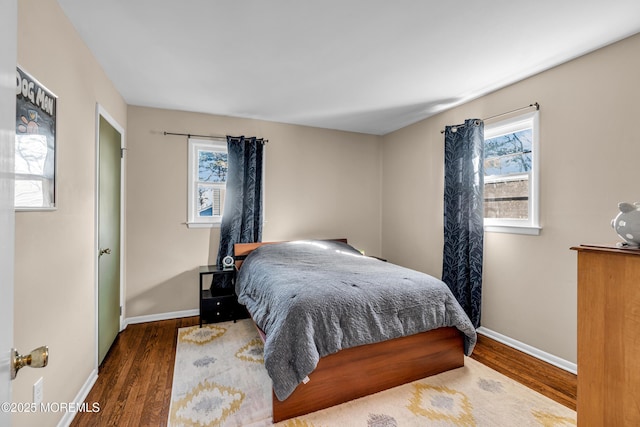 bedroom featuring wood finished floors and baseboards