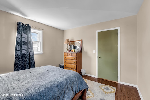 bedroom with wood finished floors and baseboards