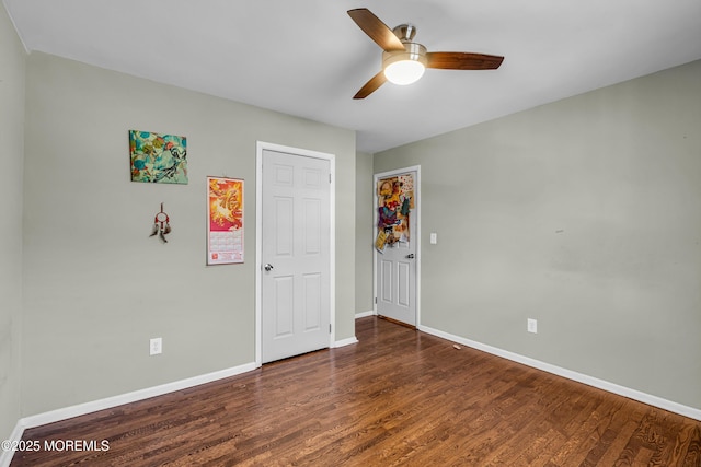 unfurnished bedroom featuring ceiling fan, baseboards, and wood finished floors