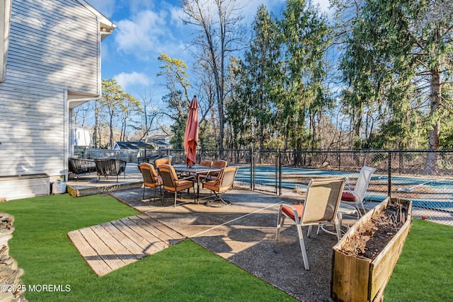 view of patio featuring fence and a pool