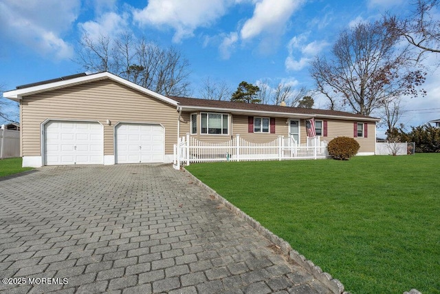 ranch-style house with a front yard, decorative driveway, fence, and a garage