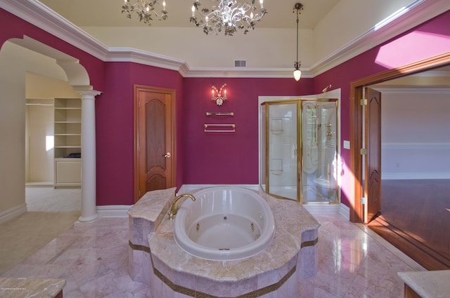 bathroom featuring a jetted tub, a shower stall, decorative columns, and baseboards