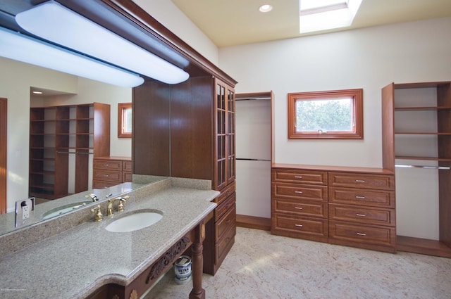 bathroom with recessed lighting and a sink