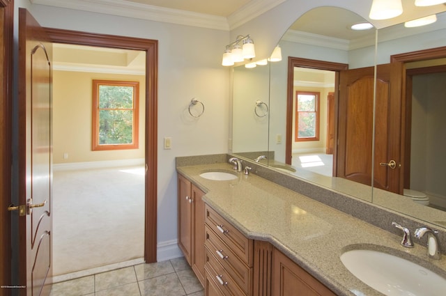 full bath with a wealth of natural light, ornamental molding, and a sink