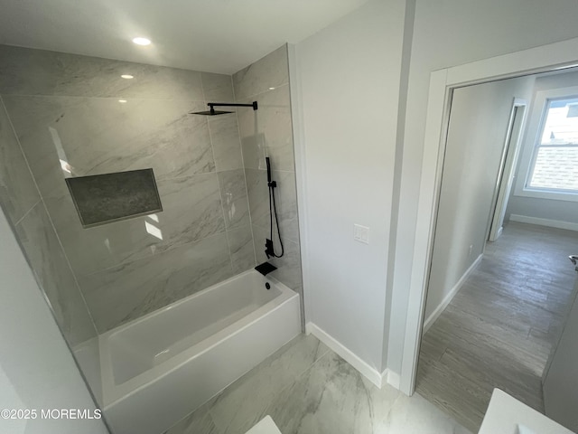 bathroom with recessed lighting, marble finish floor,  shower combination, and baseboards