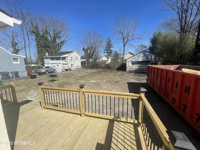 deck featuring an outdoor structure and fence