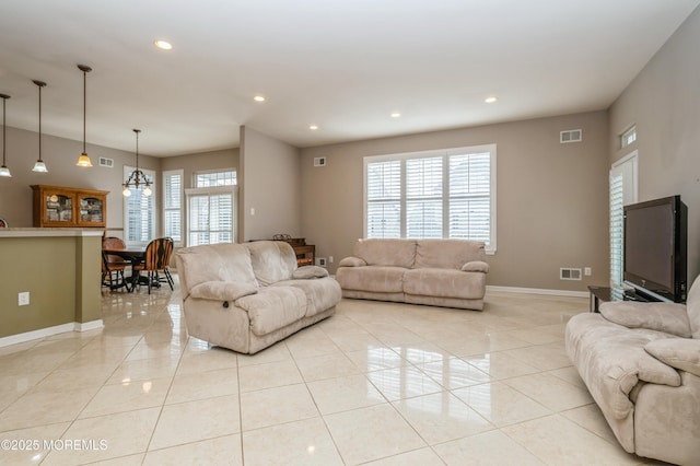 living room with baseboards, light tile patterned flooring, a wealth of natural light, and recessed lighting