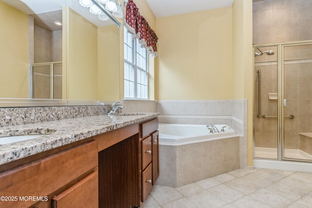 bathroom featuring a sink, double vanity, a shower stall, and a bath