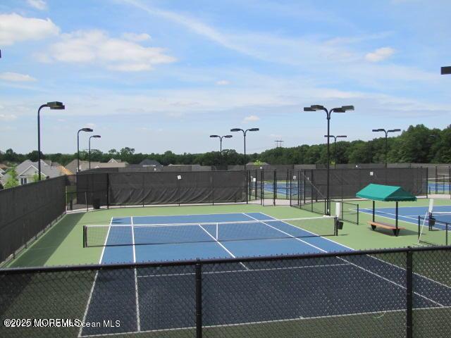 view of sport court featuring fence