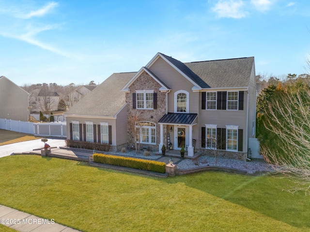 view of front of house featuring stone siding, fence, a chimney, and a front lawn