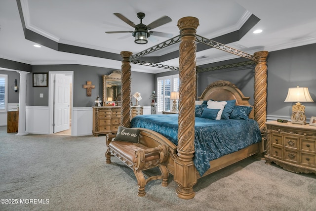 carpeted bedroom with ornamental molding, recessed lighting, wainscoting, and decorative columns