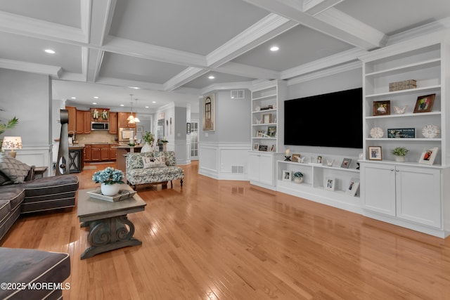 living room featuring light wood-style floors, built in features, a decorative wall, and beamed ceiling