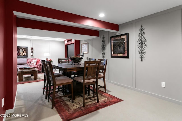 dining room with carpet floors, beam ceiling, and recessed lighting