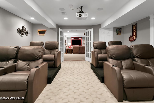 carpeted cinema room with recessed lighting, french doors, and visible vents