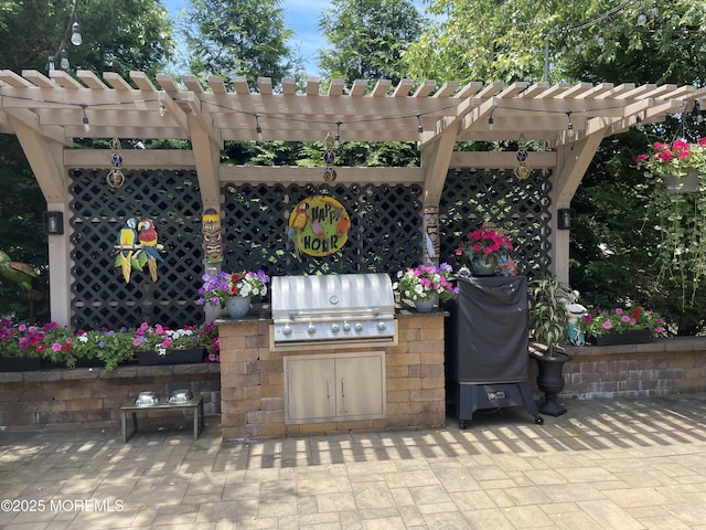 view of patio / terrace with exterior kitchen, a grill, and a pergola