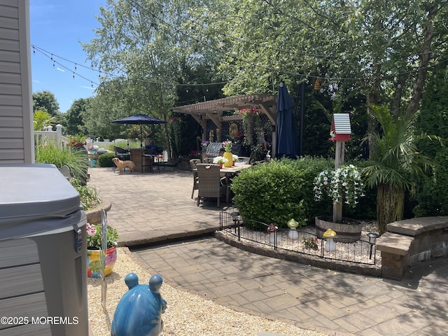 view of patio with outdoor dining space, fence, and a pergola