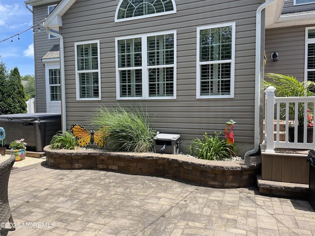 view of patio / terrace with a hot tub