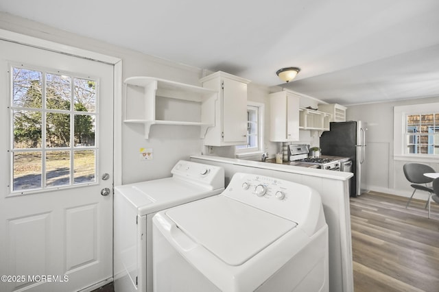 laundry room with laundry area, independent washer and dryer, and wood finished floors