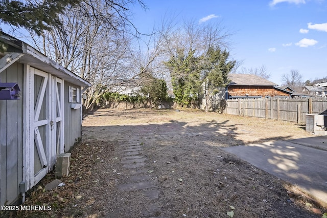 view of yard with a fenced backyard and central AC unit