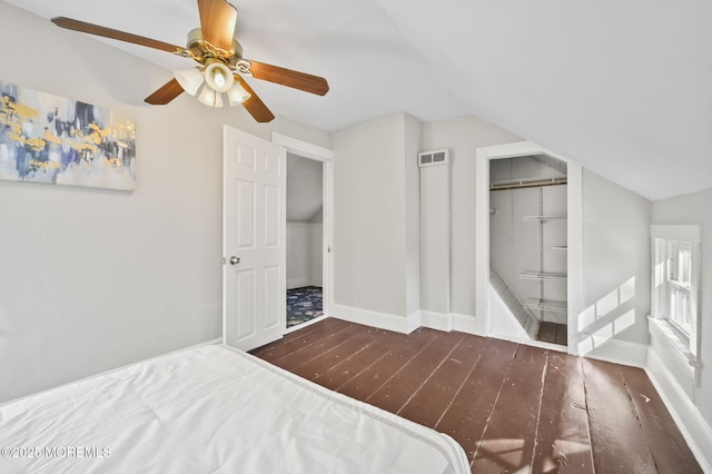 bedroom with dark wood-style floors, lofted ceiling, visible vents, ceiling fan, and baseboards