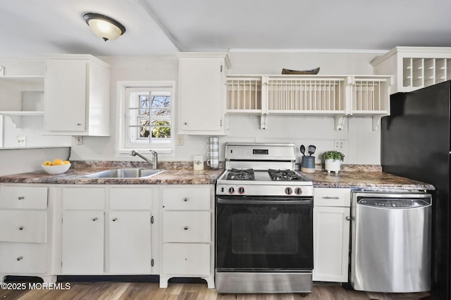 kitchen with open shelves, dark countertops, a sink, and gas range