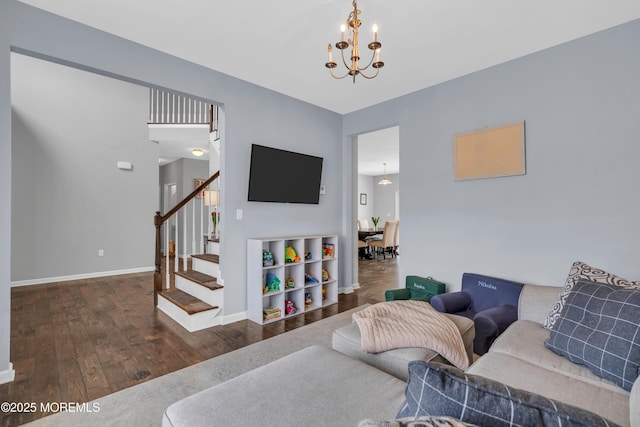 living area featuring baseboards, dark wood-style flooring, stairway, and an inviting chandelier