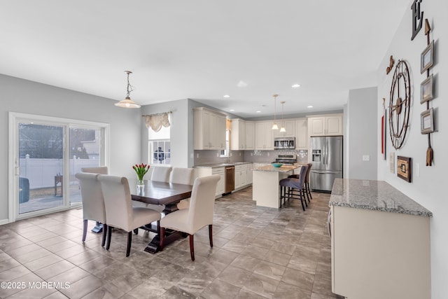 dining space featuring recessed lighting