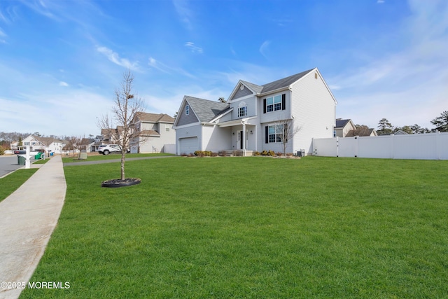 view of front of home with a front lawn, fence, and a residential view