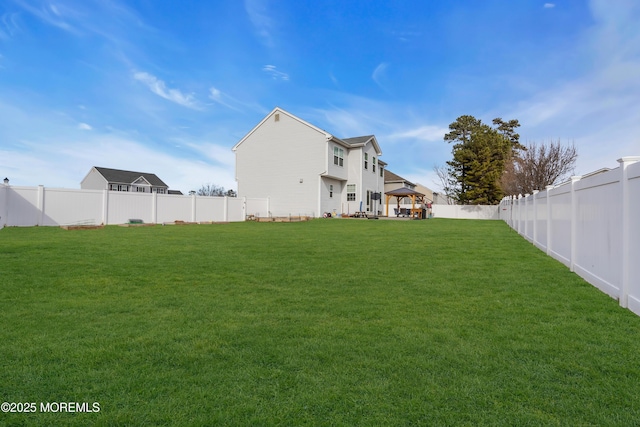 view of yard featuring a fenced backyard and a gazebo