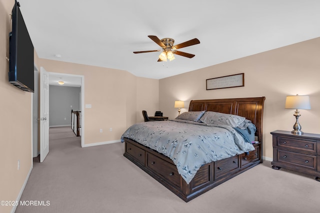 bedroom featuring ceiling fan, baseboards, and light colored carpet