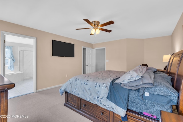 bedroom with baseboards, ceiling fan, ensuite bath, and light colored carpet