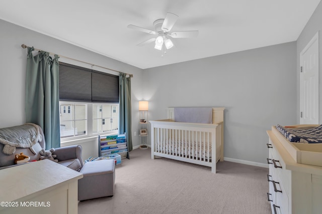 bedroom with light carpet, a ceiling fan, and baseboards